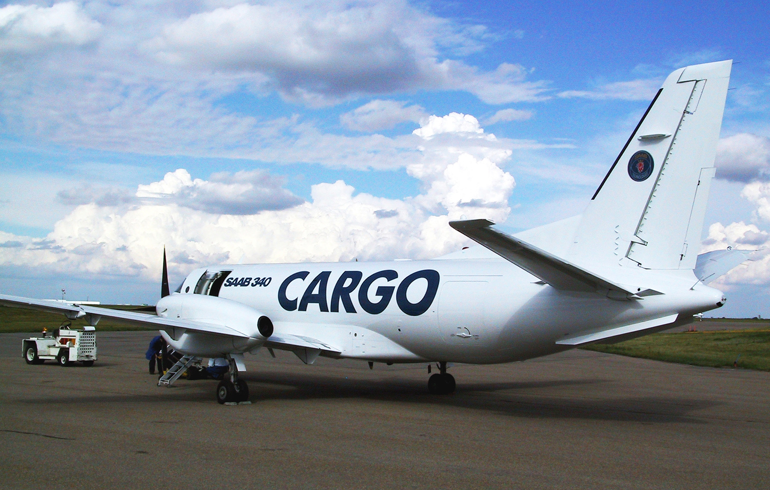 Saab 340 cargo charter aircraft on runway in daytime
