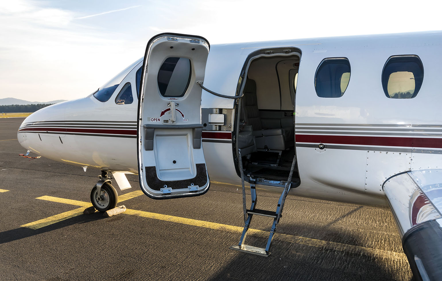 Cessna Citation small cargo charter aircraft on runway in morning