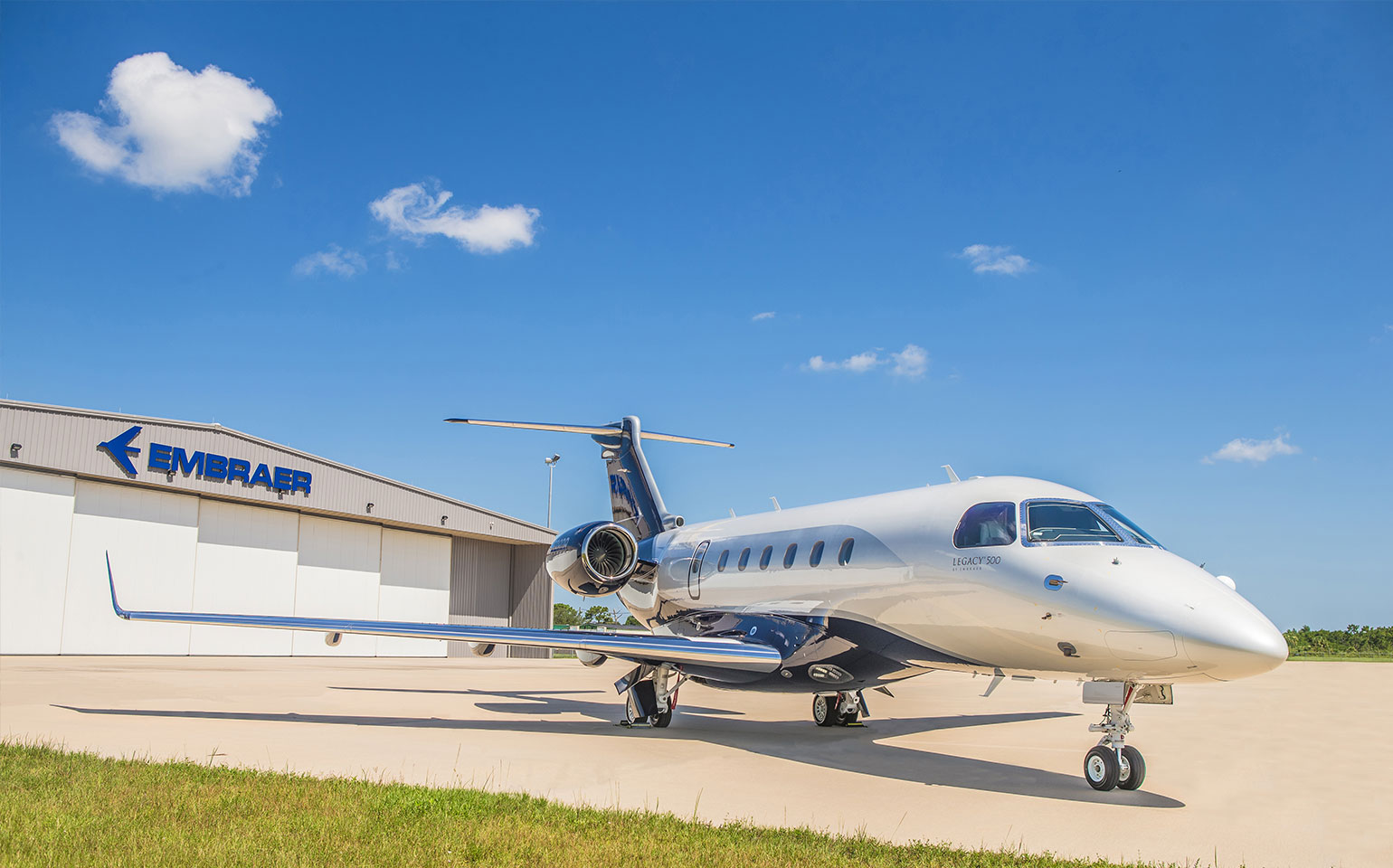 Embraer Legacy 500 private jet charter outside hanger 