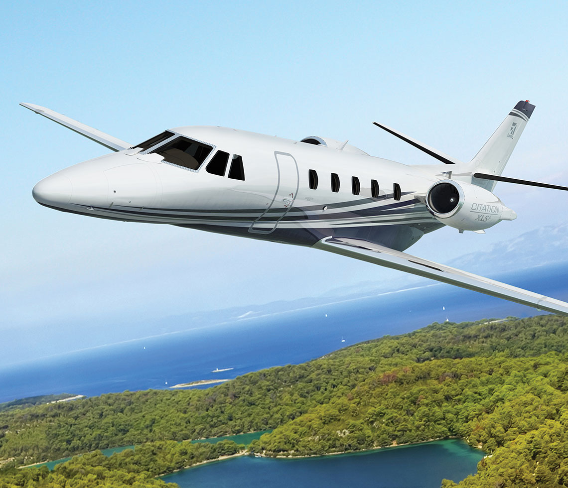 Cessna Citation XLS private jet flying near beach