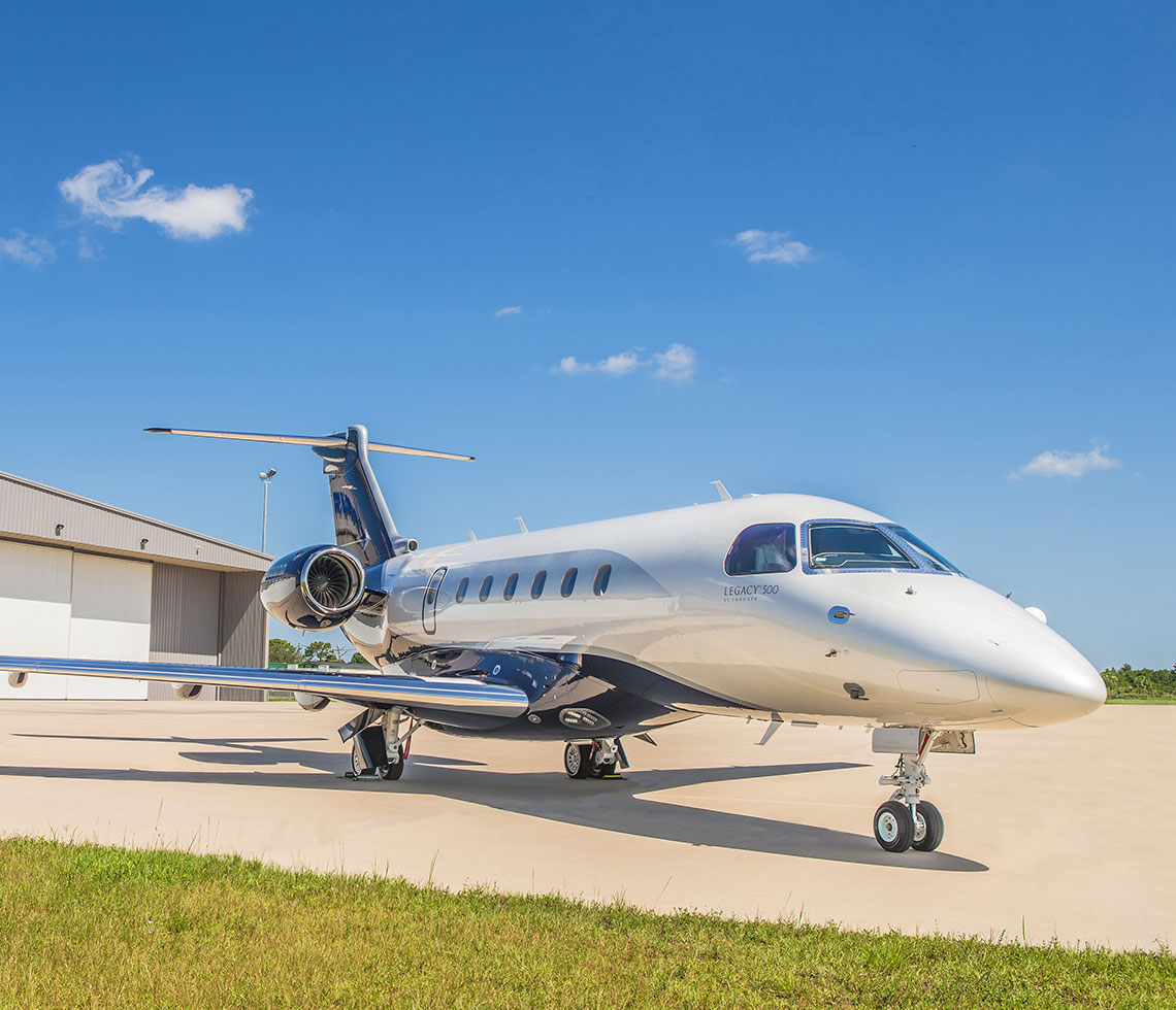 Embraer Praetor 500 private jet charter outside hanger 