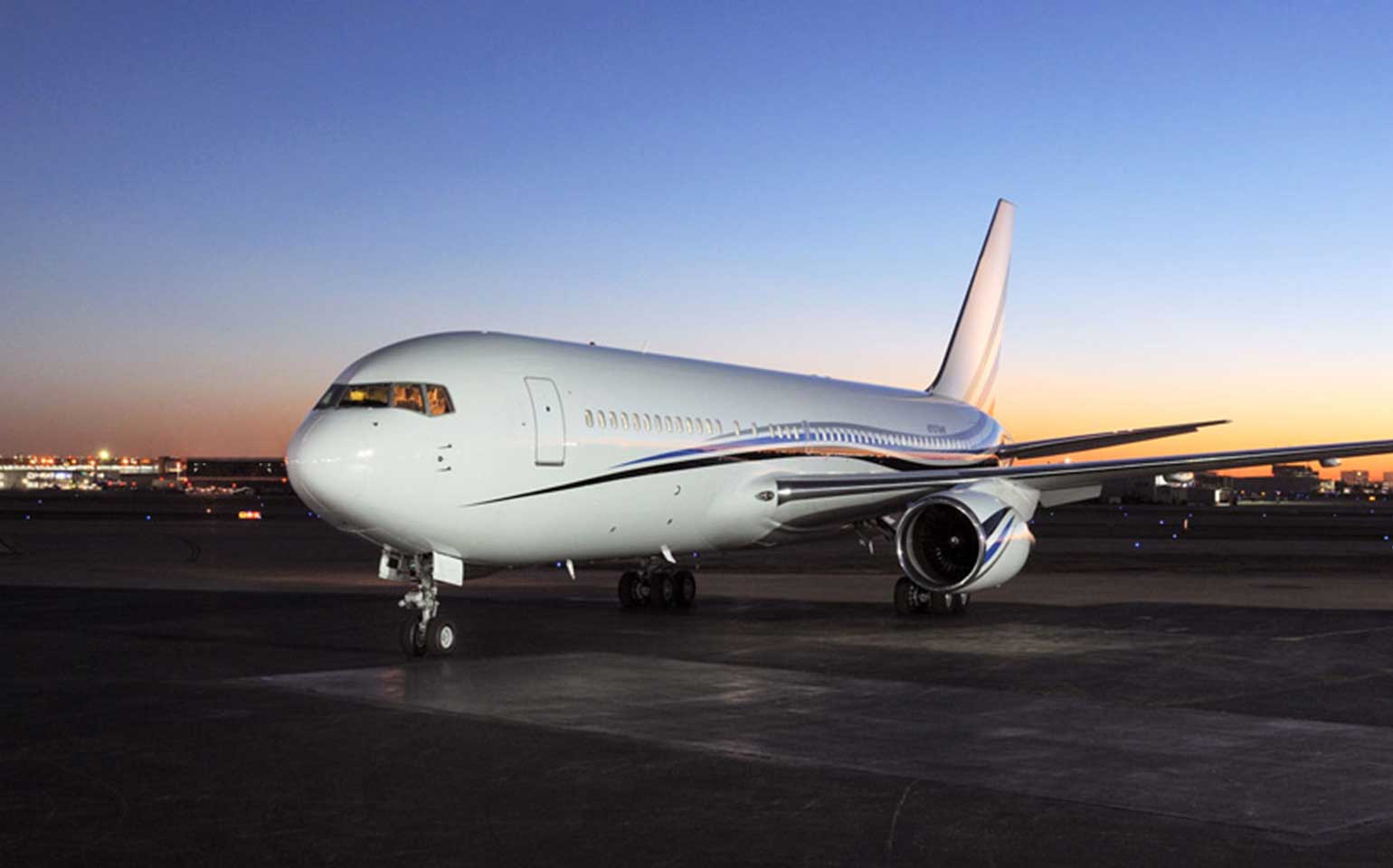 Boeing 767-VIP private aircraft charter on runway at night